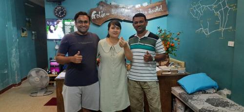 three men and a woman standing in a room at Golden Bell Backpacker Hostel in Ninh Binh