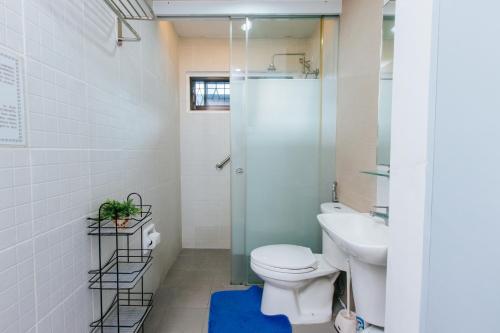 a bathroom with a toilet and a sink at Bahay Ni Kikay Vacation Rental - WiFi Included in General Santos