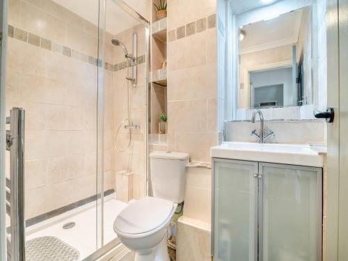 a bathroom with a toilet and a sink and a shower at Crynant Countryside Retreat in Crynant