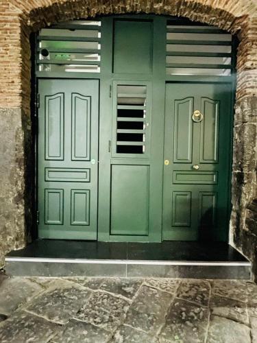 a green front door of a building at Alex mary home in Naples