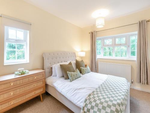 a bedroom with a bed and two windows at Apple Orchard - Uk45170 in Southwell