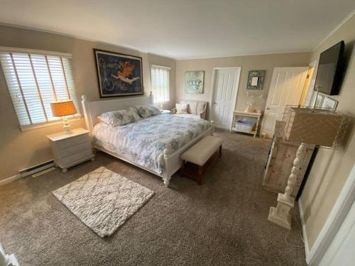 a bedroom with a bed and a television in it at BEACH FRONT Luxury Home + Direct Beach Access in Ocean City