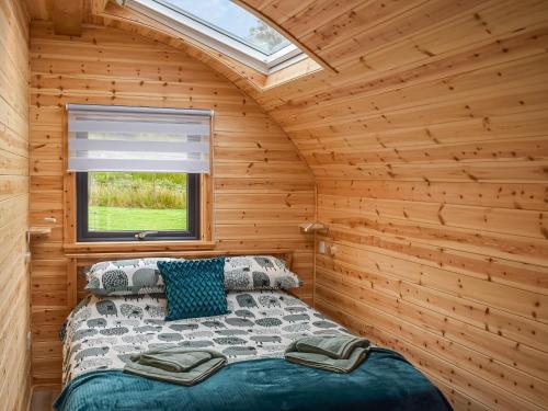 a bedroom with a bed in a wooden cabin at Black Grouse - Ukc6790 in Fort William