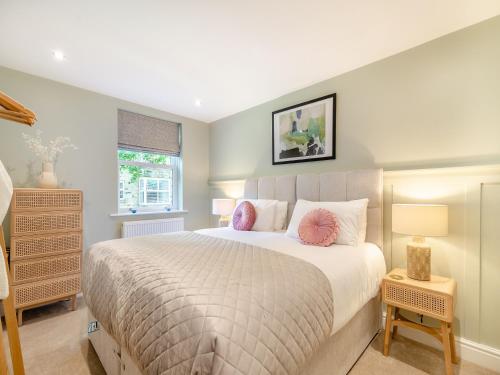 a bedroom with a large bed with pink pillows at The Chambers in Richmond