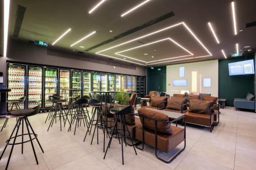 a lobby with leather furniture and bar stools at Dayin East Nanjing Road & The Bund in Shanghai