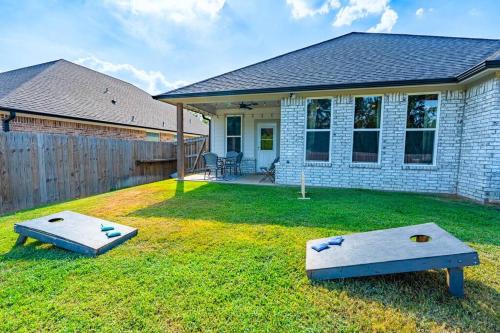 a house with a yard with two ping pong tables at Pet Friendly, King Bed, Fire Pit in Tyler