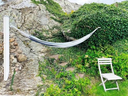 a hammock and a chair laying on a rock at 4 star holiday home in ELLÖS-By Traum in Ellös
