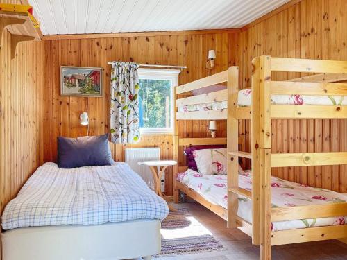 a bedroom with two bunk beds and a bed at Holiday home BERGKVARA X in Bergkvara