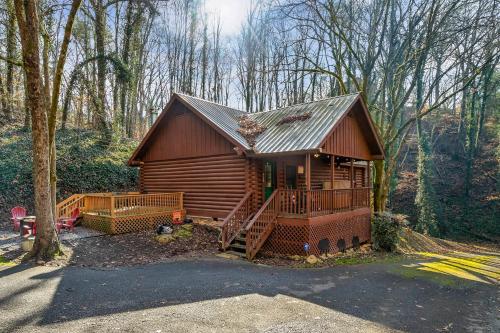 a log cabin in the woods with a porch at Bear Nakid in Pigeon Forge