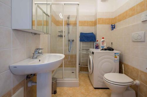 a bathroom with a sink and a toilet and a shower at Apartment in Pacengo - Gardasee 45414 in Pacengo di Lazise
