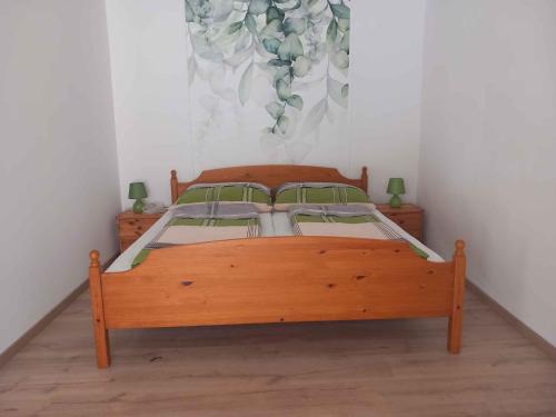 a bedroom with a wooden bed in a room at Apartment in Balatonlelle 45321 in Balatonlelle