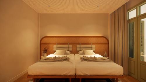 Un ou plusieurs lits dans un hébergement de l'établissement Coconut Hotel