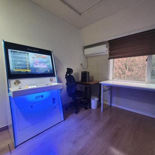 a room with a desk and a large screen television at Seoul venture town stn #2 7mins, near forest room in Seoul