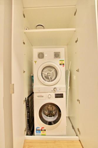 a washer and dryer in a small room at Nest Apartments on Rose Lane in Melbourne