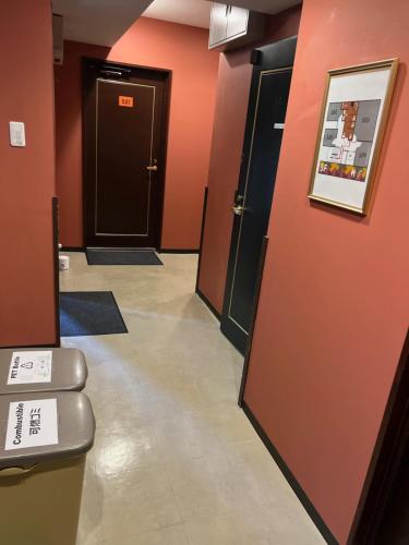 a hallway with two doors and a hallway with a toilet at TenTen Guesthouse in Asakusa in Tokyo