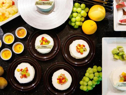 a table topped with plates of food and fruit at Hakone Kowakien Tenyu in Hakone