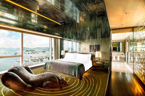 a hotel room with a bed and a large window at W Hong Kong in Hong Kong