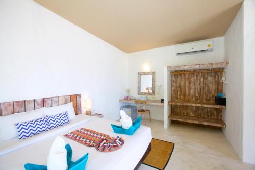 a living room with a bed and a table at Lime N Soda Beachfront Resort in Thongsala