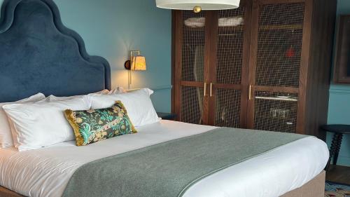 a bedroom with a large bed with a pillow on it at Hotel Indigo - Exeter by IHG in Exeter