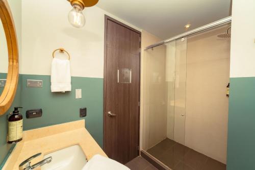 a bathroom with a sink and a shower at Socialtel Parque 93 Bogota in Bogotá