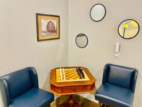 a room with two chairs and a chessboard and mirrors at Eagle Nest River Views Hot Tub Games Sleeps 6 in Ahwahnee