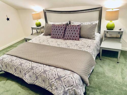 a bedroom with a large bed with two tables at Eagle Nest River Views Hot Tub Games Sleeps 6 in Ahwahnee