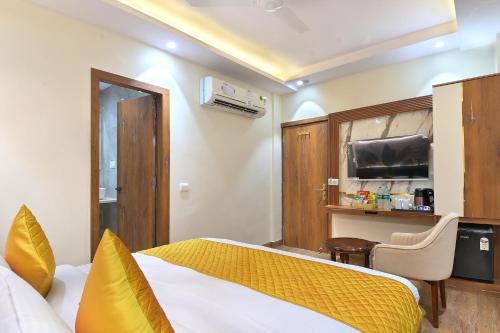 a hotel room with a bed and a television at The Saina International Delhi - By La Exito Hotels in New Delhi