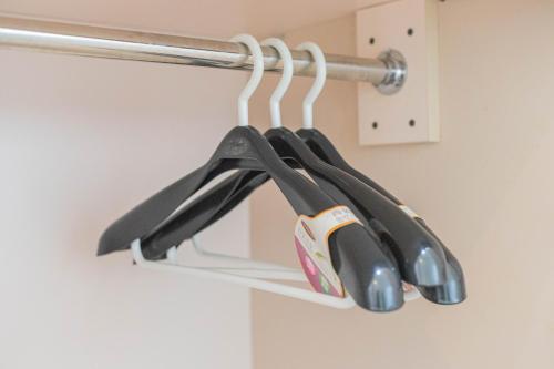 a group of utensils hanging from a hook at Mandhasativa Homestay in Singaraja
