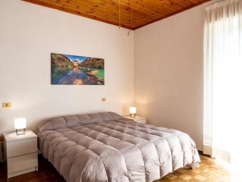 a bedroom with a large bed and two night stands at Casa Verdi Colli in Montecastrilli