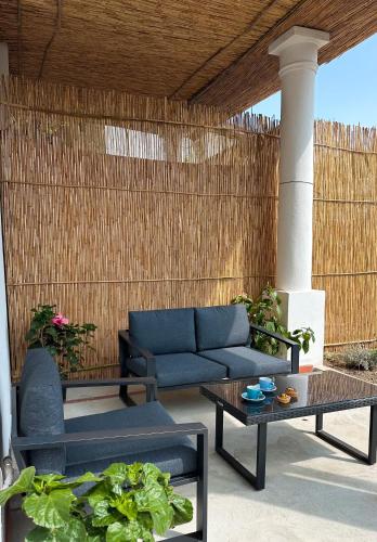 a patio with a couch and tables and a fence at Il Cigno B&B in Capri