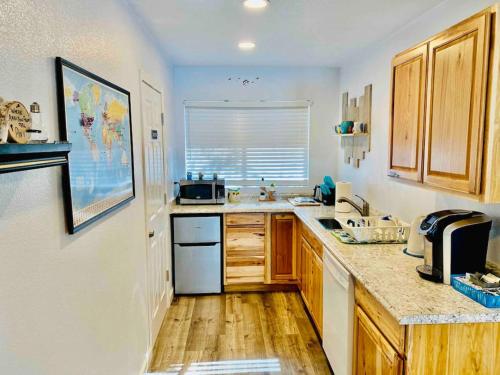 a kitchen with wooden cabinets and a counter top at Owl Nest Hot Tub Sleeps 3 Yosemite in Ahwahnee