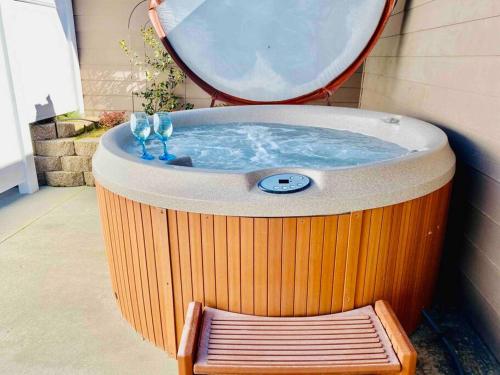 a hot tub with a bench and a mirror at Owl Nest Hot Tub Sleeps 3 Yosemite in Ahwahnee