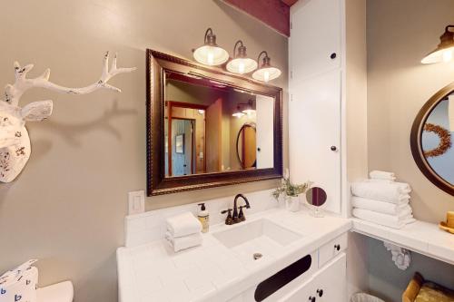 a bathroom with a sink and a mirror at Fernwood in Shaver Lake