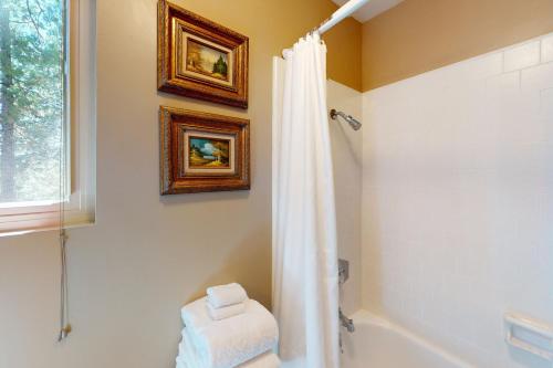 a bathroom with a shower curtain and a tub at Fernwood in Shaver Lake
