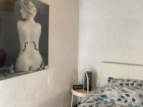 a bedroom with a picture of a woman in a bikini at Studio face Métro B l'hôpital Lyon Sud Fac de médecine in Pierre-Bénite