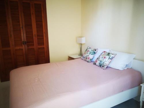 a bedroom with a bed with two pillows on it at Spacious apartment La Mata pool&beach in Torrevieja
