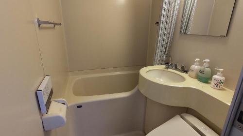 a small bathroom with a sink and a toilet at Matsunoki-tei in Otari