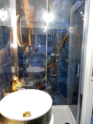 a bathroom with a shower with a sink and a toilet at Alex mary home in Naples