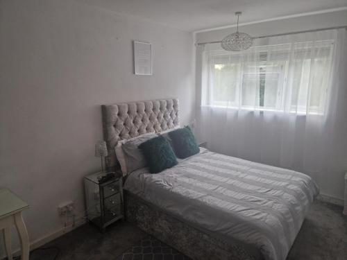 a bedroom with a large bed with a window at Immaculate 1-Bed Apartment in Woodford Green in Woodford Green