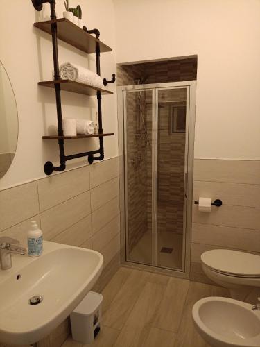 a bathroom with a shower and a sink and a toilet at Casa del Fiordaliso in San Benedetto del Tronto
