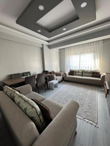 a living room with couches and a couch and a table at Konforlu in Aydın