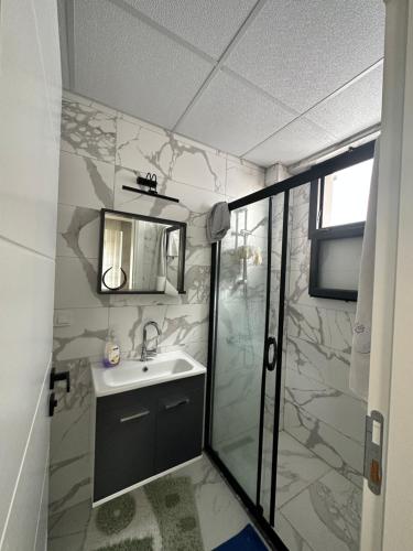 a bathroom with a sink and a shower at Konforlu in Aydın