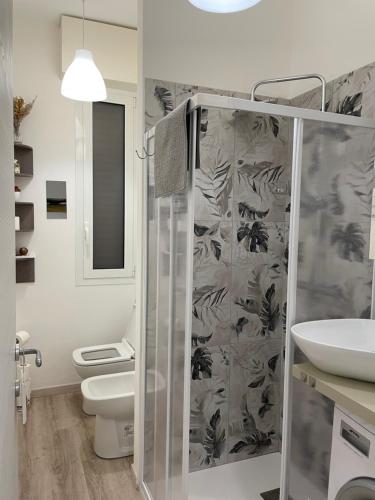 y baño con ducha, aseo y lavamanos. en Nuova Casa di Mattia Bologna en Bolonia