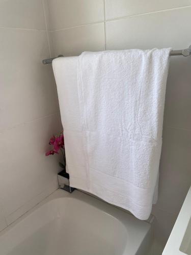 a white towel hanging on a towel rack in a bathroom at Fourways Luxe Suite in Sandton