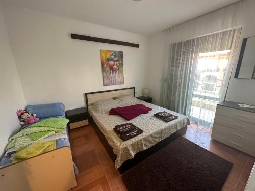 a bedroom with a bed and a dresser at PANTELI APART HOUSE in Aheloy