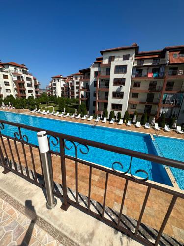 a swimming pool on a balcony with buildings at PANTELI APART HOUSE in Aheloy