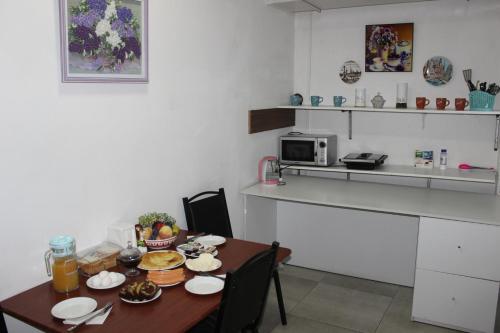 a small kitchen with a table with food on it at Hostel Near The Square in Tbilisi City