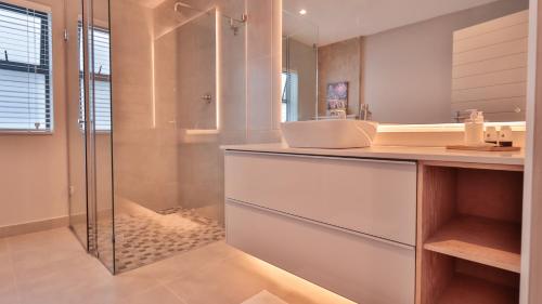 a bathroom with a sink and a shower at @201 Golf Estate in Mossel Bay