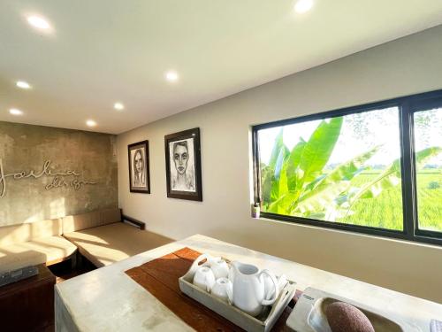 a room with a bed and a large window at Ocean Villa - Joshua District in Tabanan