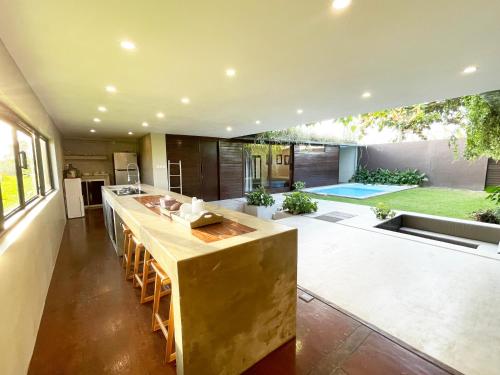 an open kitchen with a large island in a house at Ocean Villa - Joshua District in Tabanan